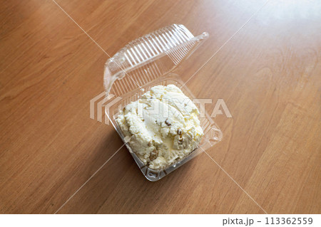 curd mass with raisins in plastic packaging on the table 113362559