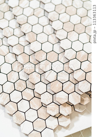 In the process of mounting peel and stick mosaic tiles onto a foam board, perfect for enhancing a food photography studio's aesthetic. In the process of mounting peel and stick mosaic tiles onto a foam board, perfect for enhancing a food photography studio's aesthetic. 113363113