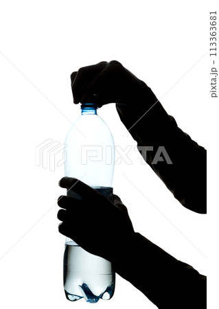 Male hands open a bottle of water to drink - silhouette 113363681