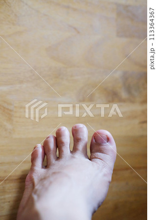 Closed up female feet with french nails on wood floor, Healthy care and medical concept 113364367