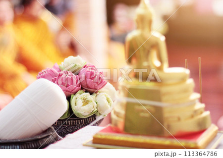 Beautiful pink lily and lotus flowers decoration on Engagement bowl for pray Buddha statue.Thai wedding culture tradition. 113364786