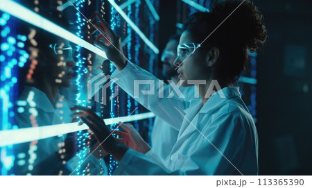 Researchers discuss genetic code findings on a screen in a lab 113365390