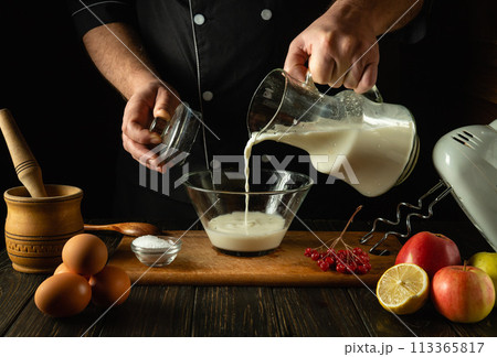The chef prepares a delicious breakfast or lunch with eggs and milk. Menu idea for a restaurant or hotel. Dairy diet concept 113365817