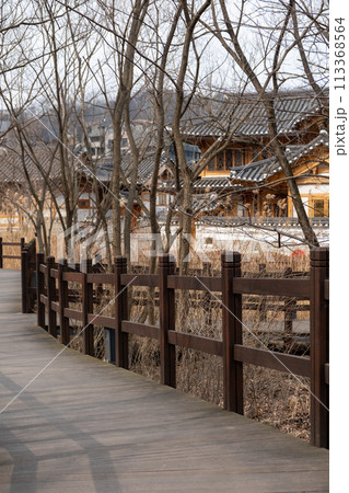 Wooden path in Eunpyeong Hanok Village, the largest neo-hanok residential complex in the capital area which surrounded by hills and mountains in Seoul, South Korea 113368564