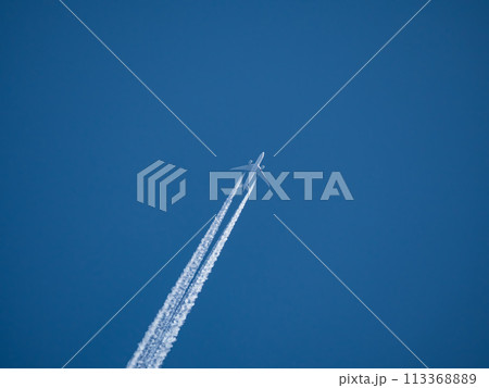 Two engines commercial airliner flying on a high route with contrail 113368889