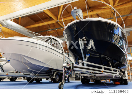 Many small big ship yachts at boat show exhibition indoors hall. Marine fishing yachting sailing vessel expo commercial trading business. Modern recreation sport water transport fair 113369463