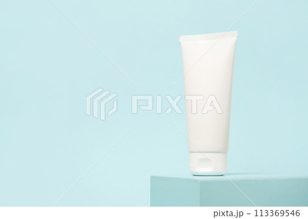 White cosmetic tube on the podium on blue background, copy space White cosmetic tube on the podium on blue background, copy space 113369546