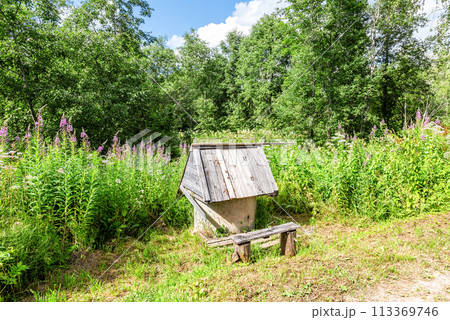 Traditional wooden water well at the countryside in summer 113369746