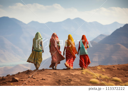 Indian women in colorful sari on top of hill 113372222