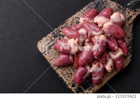 Raw chicken hearts with salt, spices and herbs 113372422