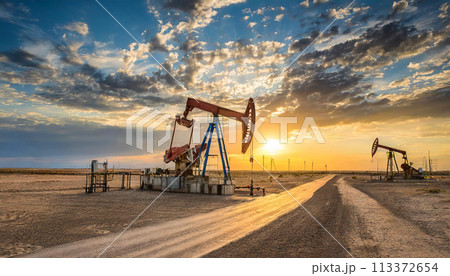 Oil well station in the desert with a beautiful sky sunset Oil well station in the desert with a beautiful sky sunset 113372654