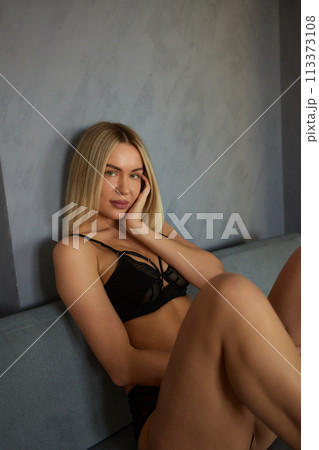 Showing body. Beautiful woman in underwear is posing indoors. Showing body. Beautiful woman in underwear is posing indoors. 113373108