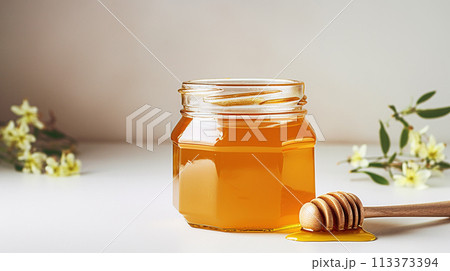 Amber Honey Jar with Wooden Dipper on White Background, Organic Sweetener 113373394
