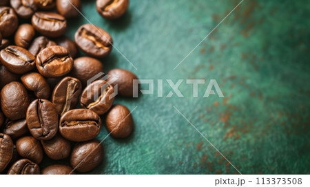 Close-up of Roasted Coffee Beans on grunge green Background with Copy Space for Caffeine Drink Concept 113373508