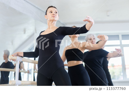 Girls in ballet class perform Batman with participation of mature female mentor Girls in ballet class perform Batman with participation of mature female mentor 113377760