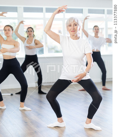 Elderly woman practicing basic movements in ballet class Elderly woman practicing basic movements in ballet class 113377880
