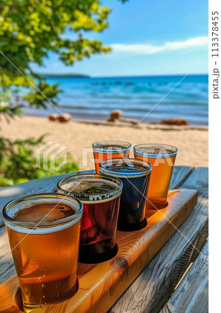 A wooden tray with five glasses of beer on it 113378455