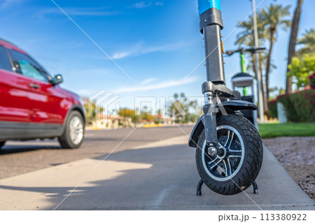 Selective focus on front wheel of a rental electric scooter in Phoenix, Arizona  113380922