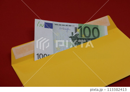 Banknotes in a yellow envelope on a red background. Bribery concept. Salary in envelopes, fraud. Banknotes in a yellow envelope on a red background. Bribery concept. Salary in envelopes, fraud. 113382413