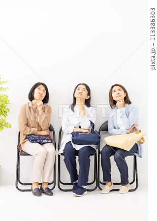 待合室に座って悩む女性 113386303