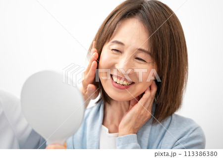 化粧品を試す60代女性 113386380