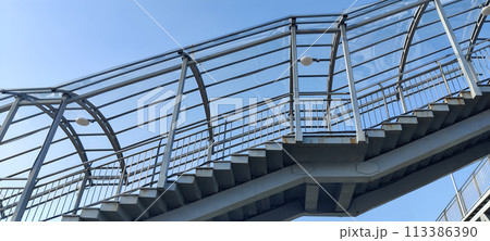 Modern steel pedestrian staircase with clear blue sky 113386390