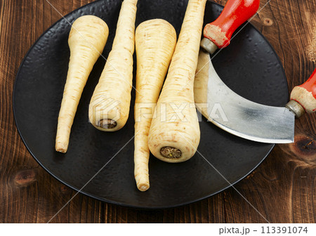 Fresh parsnip roots on wooden table. Fresh parsnip roots on wooden table. 113391074