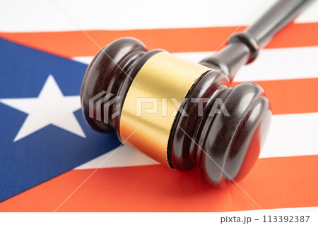 Puerto rico for judge lawyer and US dollar banknotes on USA America flag, finance concept. Puerto rico for judge lawyer and US dollar banknotes on USA America flag, finance concept. 113392387