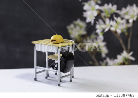 学校のイメージ ミニチュアの学校机とイス、ランドセル、黒板、桜の花 学校のイメージ ミニチュアの学校机とイス、ランドセル、黒板、桜の花 113397465