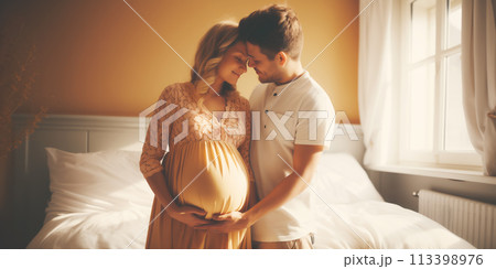 Young couple expecting a baby sitting indoors. Concept of family. 113398976