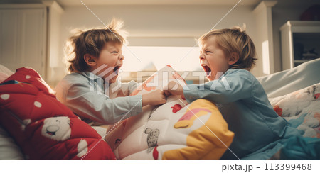 Siblings having fight with pillows at home. Concept of conflict and family relation. 113399468