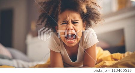 Little angry girl shouting in her room. Concept of emotions and family relation. 113400513