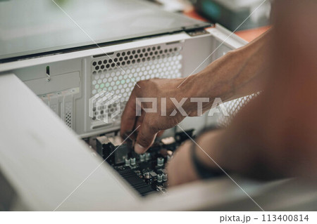 Digital Craftsman : An engineer's hands in action, displaying the meticulous art of personal computer customization and repair 113400814