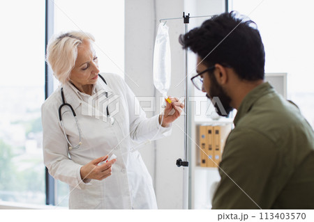 Medical specialist checking drug solution before dripping medicine. Medical specialist checking drug solution before dripping medicine. 113403570