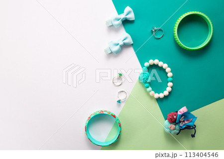 Little girls accessories on a white and green background, flat lay Little girls accessories on a white and green background, flat lay 113404546
