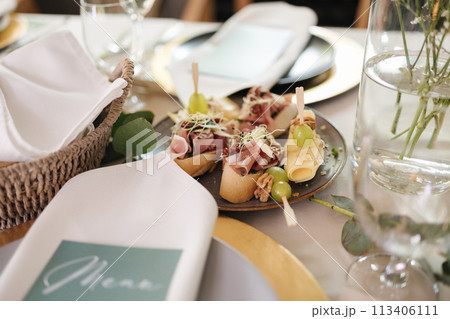 Close-up of table with food in restaurant. Fresh and healthy snack on plate. Served table 113406111