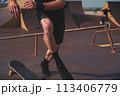 Skateboarder trains to perform stunts. High quality photo 113406779