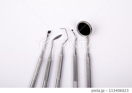 Set of dental instruments on a white background. Health and hygiene Set of dental instruments on a white background. Health and hygiene 113406823