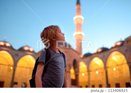 Preteen boy visiting The Blue Mosque -Sultan Ahmed Mosque. Tourist attraction of Istanbul city, Turkey 113406925