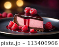 A delectable raspberries cheesecake topped with a heavenly syrup and adorned with fresh berries 113406966