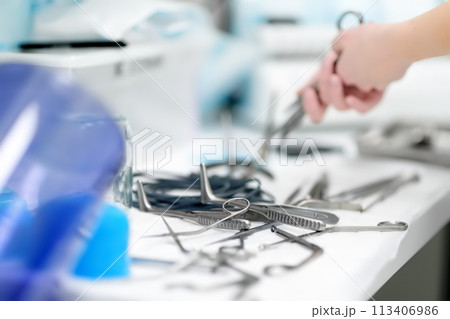 Nurse preparing surgical medical instruments for sterilizing after operation. Surgical tools kit. Nurse preparing surgical medical instruments for sterilizing after operation. Surgical tools kit. 113406986