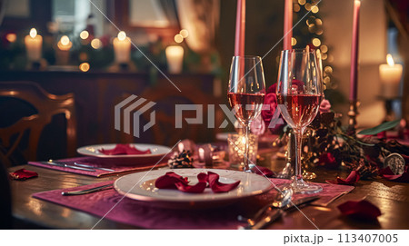 Festive table setting  with cutlery, candles and beautiful red flowers in vase 113407005
