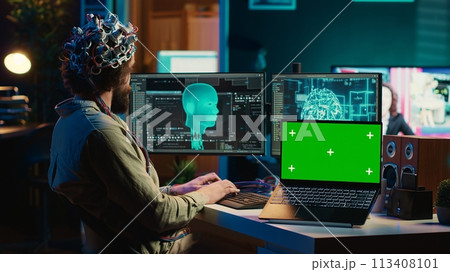 Computer scientist uploading brain into cyberspace, gaining digital persona using green screen laptop. Neuroscientist merging mind with AI, uploading consciousness into chroma key device, camera A Computer scientist uploading brain into cyberspace, gaining digital persona using green screen laptop. Neuroscientist merging mind with AI, uploading consciousness into chroma key device, camera A 113408101