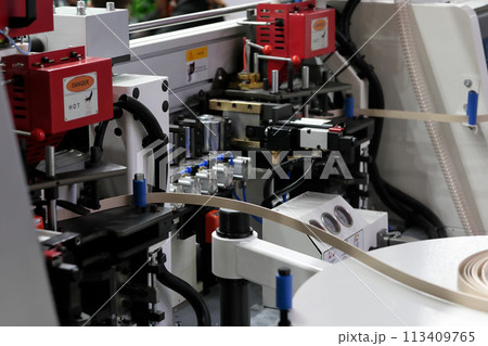 double side automatic edge banding machine closeup double side automatic edge banding machine closeup 113409765