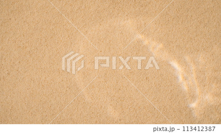 Yellow clean sand with wavy patterns under clear water Yellow clean sand with wavy patterns under clear water 113412387