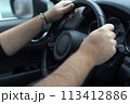 Hands on a steering wheel 113412886