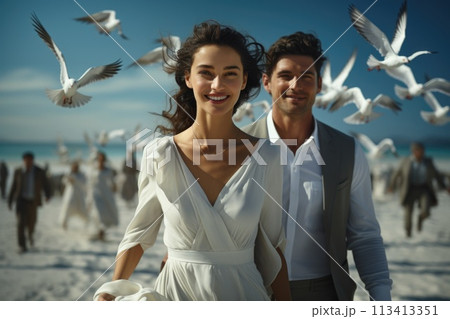 Capturing love on the beach: a beautiful couple shares intimate moments by the sea, surrounded by seagulls, enjoying the serenity, romance, and breathtaking scenery of their coastal paradise getaway. 113413351