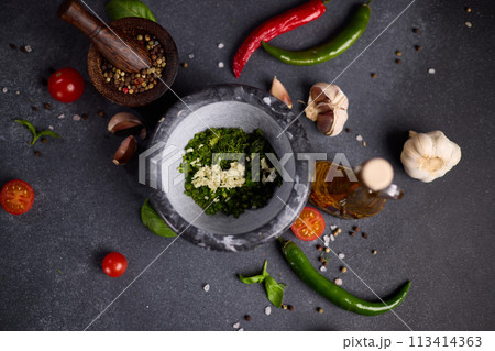 stone mortar with green sauce chopped ingredients stone mortar with green sauce chopped ingredients 113414363