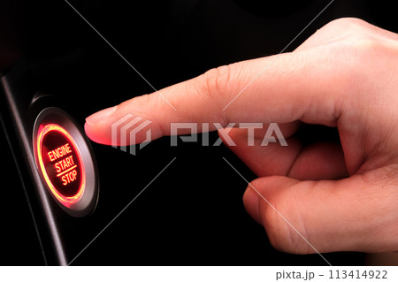 The driver's hand is pressing the car start button. Concept of transportation and technology 113414922