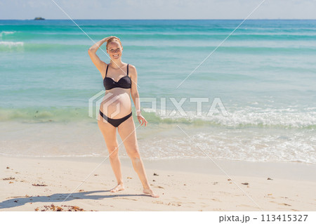 Harmonizing mind and body, a pregnant woman gracefully practices yoga on the beach, embracing the serenity of the seaside for a tranquil and mindful pregnancy experience Harmonizing mind and body, a pregnant woman gracefully practices yoga on the beach, embracing the serenity of the seaside for a tranquil and mindful pregnancy experience 113415327